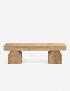 a wooden bench sitting on top of a white floor