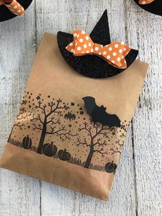 a brown paper bag with black and white polka dots on it, decorated like a witch's hat