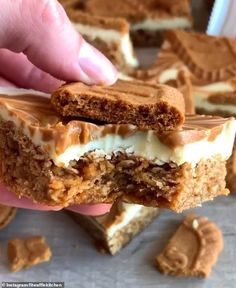 someone is holding up a piece of cake with white frosting and caramel on top