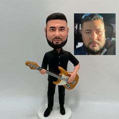 a caricature of a man holding a guitar and wearing a black shirt with a beard