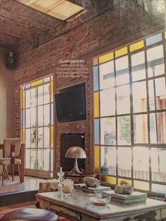 a living room filled with furniture and lots of windows