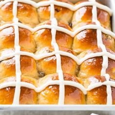 hot cross buns in a baking dish with icing