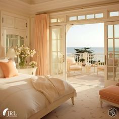 a bedroom with an open door leading to the balcony overlooking the ocean is shown in this image