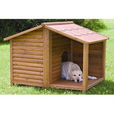 a dog is laying in a wooden dog house