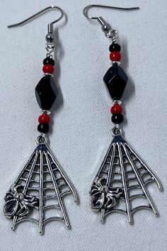 "Long Black and red spider web earrings are perfect for Halloween parties.  Approximately 3\" long from top of ear wire to bottom of spider web charm." Red Metal Halloween Earrings, Red Drop Earrings For Halloween, Red Pierced Halloween Earrings, Red Pierced Earrings For Halloween, Red Nickel-free Jewelry For Halloween, Nickel-free Red Halloween Jewelry, Handmade Black Vampire Earrings, Spooky Red Halloween Jewelry, Gothic Earrings Diy