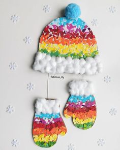 a pair of mittens made out of paper and yarn