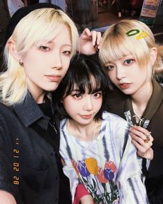 three young women posing for the camera