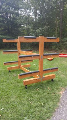 a wooden structure sitting on top of a lush green field