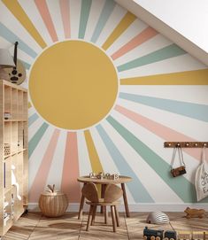 a child's room with sun painted on the wall and wooden toys in the floor