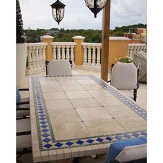 an outdoor table and chairs on a patio