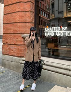 a woman taking a selfie in front of a store