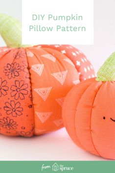 two orange pumpkins sitting next to each other on top of a white surface with the words diy pumpkin pillow pattern