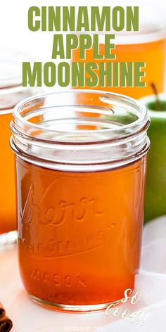 a jar filled with cinnamon apple moonhine sitting on top of a table