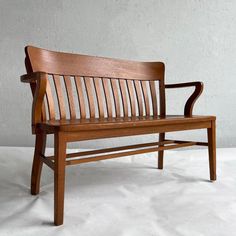 a wooden bench sitting on top of a white floor