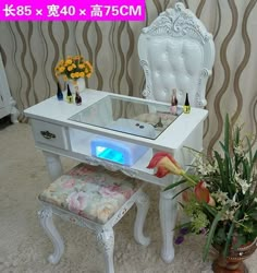 a white vanity table with a mirror on it and flowers in vases next to it