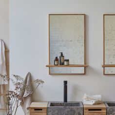 a bathroom with two sinks and mirrors on the wall