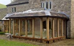 a building that has some kind of glass on it's roof and is made out of wood