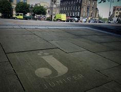 an image of a street sign on the ground with buildings in the backgroud