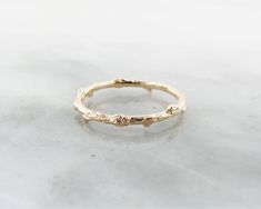 Solid Yellow Gold Ring, Slender Twig Band Available in Sizes 4-8 14k Rose Gold Rustic Signature Design Twig Band is a dainty little band that graces the hand with a touch of woodsy charm. This slender band is covered in bark-like texture and features knots and nubs that makes it resemble an actual slender branch wrapped around your finger. A unique wedding band idea, or even just a great accented stacking ring! This is a delicate addition to our rustic range of designs in 14K Yellow Gold. Weighs Small Wedding Rings, Twig Wedding Band, Textured Wedding Band, Gold Twigs, Twist Wedding Band, Unique Wedding Band, Woodland Jewelry, Twig Ring, Unique Wedding Bands