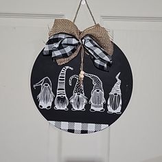 a black and white door hanger with some decorations hanging from it's side