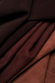 the fabric is very dark brown and it looks to be made from silk or polyester