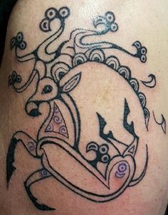 a close up of a tattoo on the back of a person's shoulder