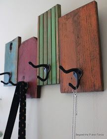 two wooden pieces are hanging on the wall with chains attached to them, and one piece is made out of wood