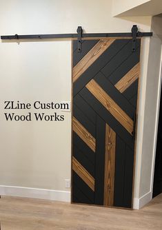 a black and brown door with the words zine custom wood works on it