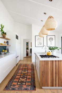 a kitchen with an area rug on the floor