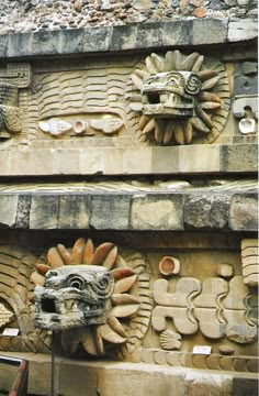 two stone carvings on the side of a building