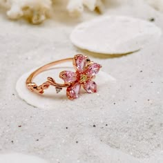 Celebrate the Spring Season with this gorgeous sparkling pink sapphire flower ring ~ perfect for everyday wear or for a special occasion. Makes the perfect gift for any occasion. * 18K Rose Gold Filled *Flower size is approximately 1x1cm * Lab created sapphire *Nickle and Lead Free *Size 6 and 7 only * Photos enlarged to show detail * Ring box included *For returns/refunds please contact me within 3 days, please ship items back in original condition within 7 days of receipt. Pink Flower Engagement Ring, Rose Gold Flower Ring, Pink Flower Ring, Cherry Blossom Ring, Cute Promise Rings, Lily Ring, Pink Wedding Rings, Bff Jewelry, Gold Flower Ring