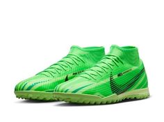 a pair of green soccer shoes on a white background with the word nike written in black