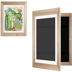 two framed pictures hang on the wall next to each other, one with an image of a dinosaur