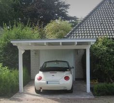 a white car parked in front of a house with a carport attached to it