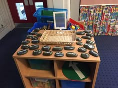 there is a table with rocks and a basket on it in the children's playroom