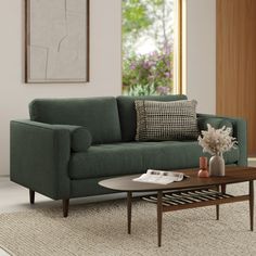 a living room scene with focus on the sofa and coffee table in the foreground