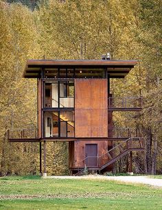 a tall wooden structure sitting in the middle of a forest