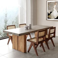 a dining room table with chairs and a painting on the wall behind it, in front of a window