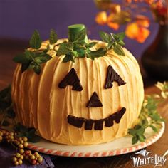 a pumpkin shaped cake sitting on top of a plate