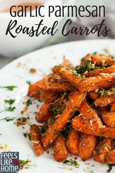 garlic parmesan roasted carrots on a white plate with text overlay that reads garlic parmesan roasted carrots