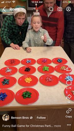 two young boys sitting at a table with christmas decorations on it