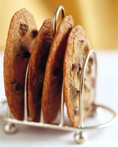 four cookies in a metal holder on a table