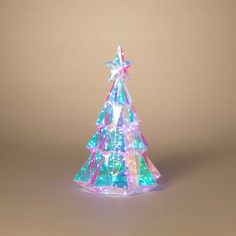 a lighted christmas tree on a brown background