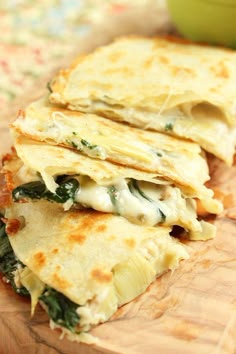 there are three quesadillas stacked on top of each other with cheese and spinach