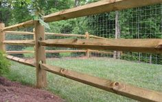 a wooden fence with wire around it