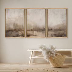 two paintings hang on the wall above a bench in a room with wooden flooring