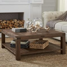 a living room with a couch, coffee table and fire place in front of a fireplace