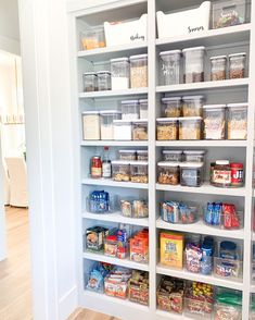 an organized pantry with lots of food and containers on the shelves in front of it