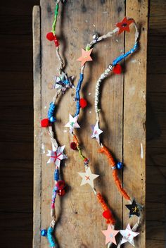 a wooden board with beads and stars on it