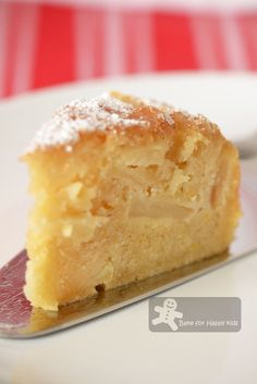 a piece of cake sitting on top of a white plate with a fork in front of it